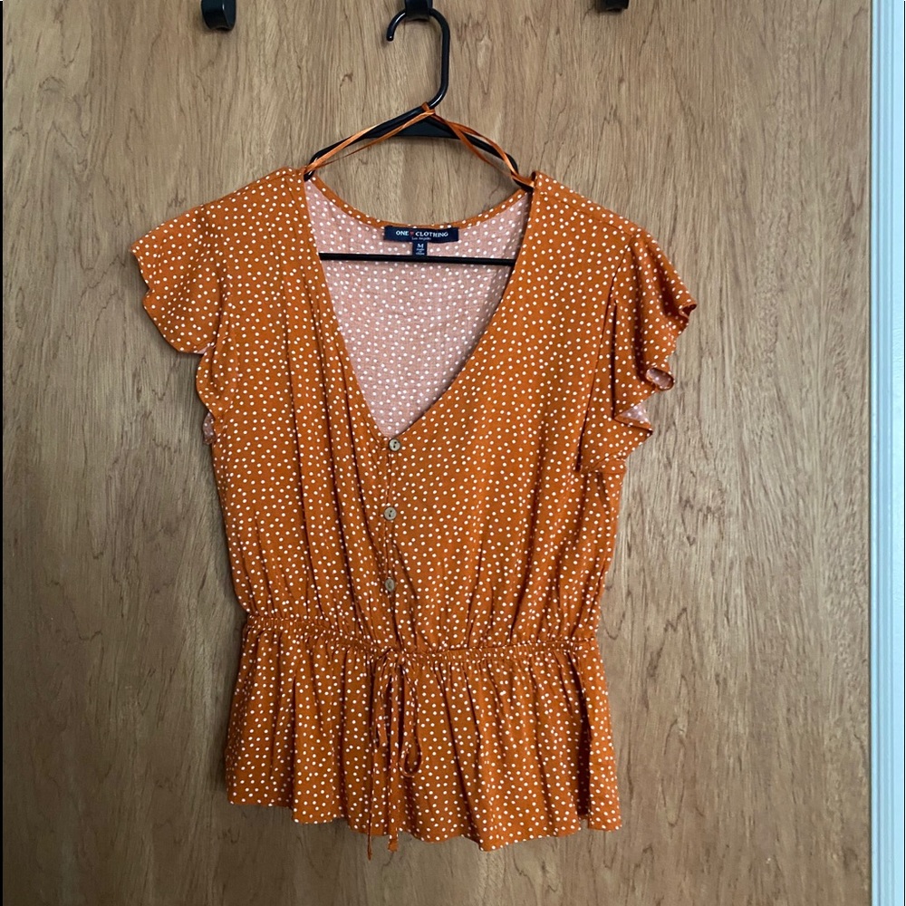 orange and white poka dot shirt